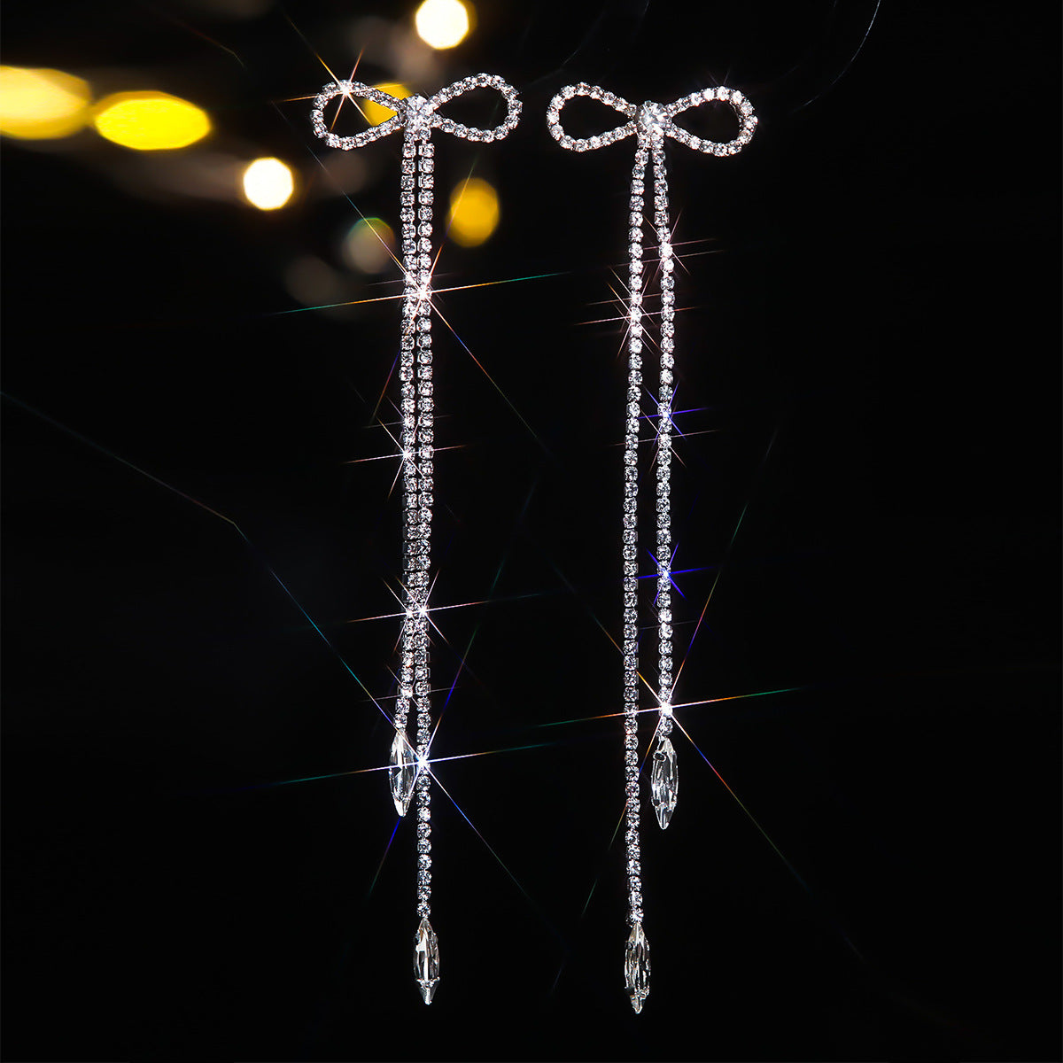 Popular, high-end luxury long fringed earrings for women, fashionable and shiny rhinestone bow stud earrings.