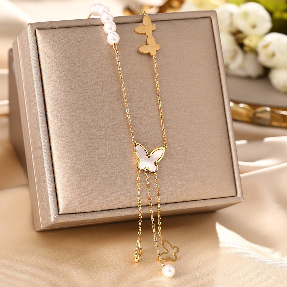 Korean version of white shell butterfly pearl necklace women's titanium steel hollow long fringe pendant fashion collarbone chain jewelry does not fade